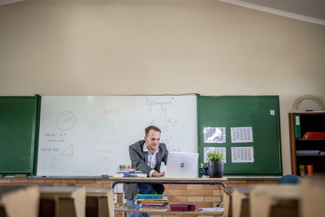 Male teacher teaching in class