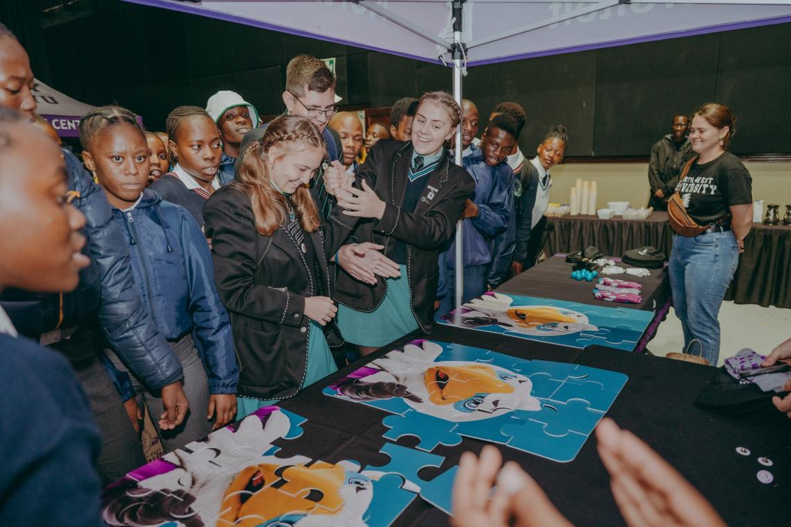 Group of school learners playing the Eagi puzzle
