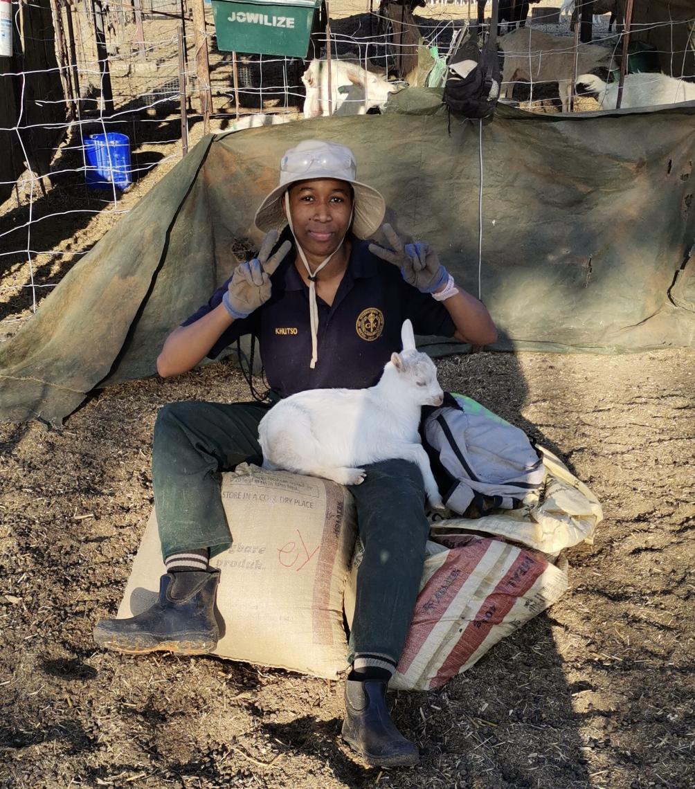 Khutso sitting with an animal