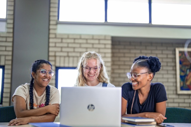 group of 3 girls working on a laptop