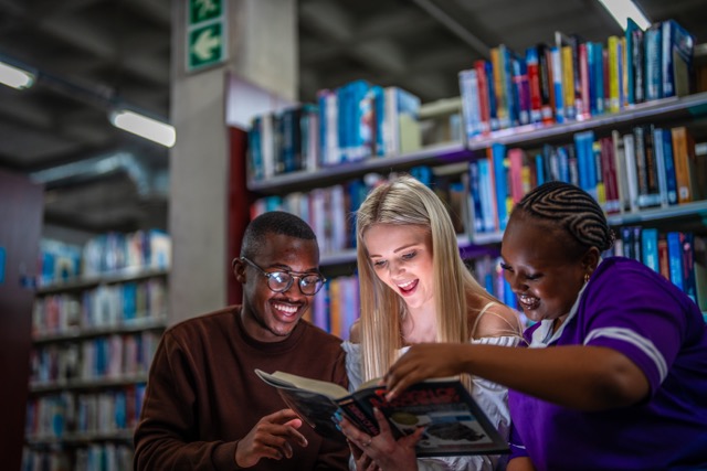 Group of students at the library discussing book