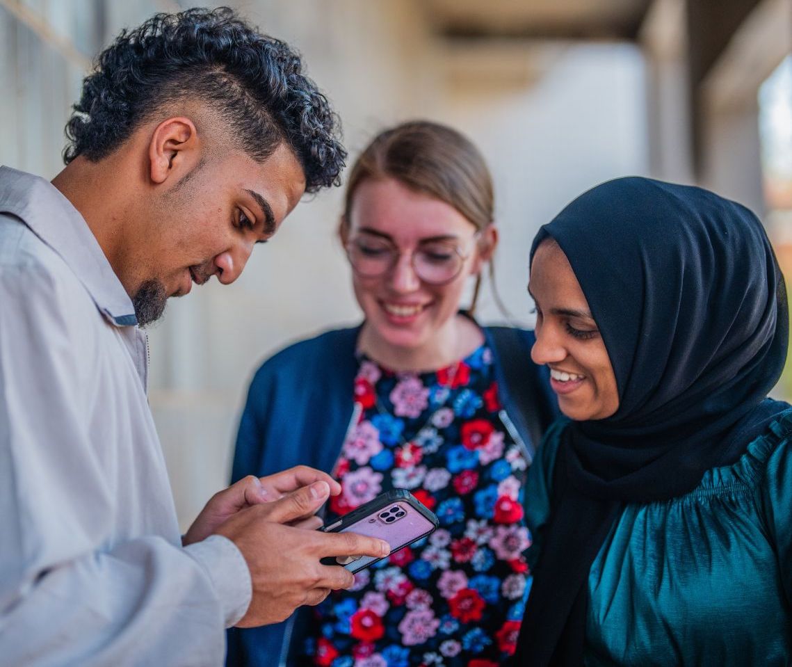 Vibrant Students looking at phone screen