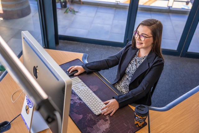 Female in office looking into computer