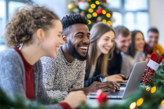 A group of people sitting on table with christmas decorations