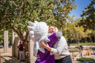 NWu Eagi hugging a white lady outdoors