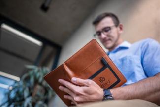 White male holding a notebook
